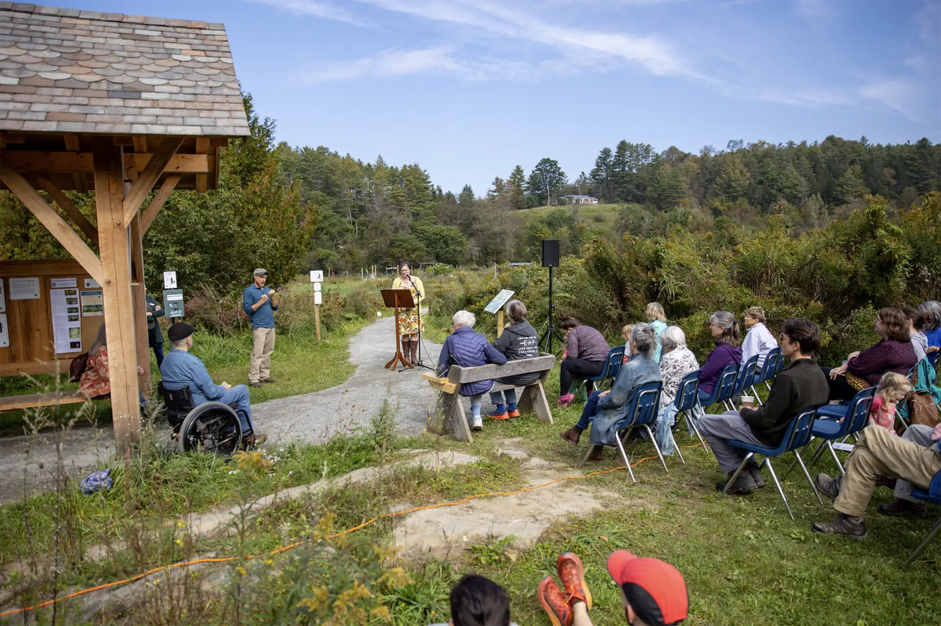 group watching speaker outdoors