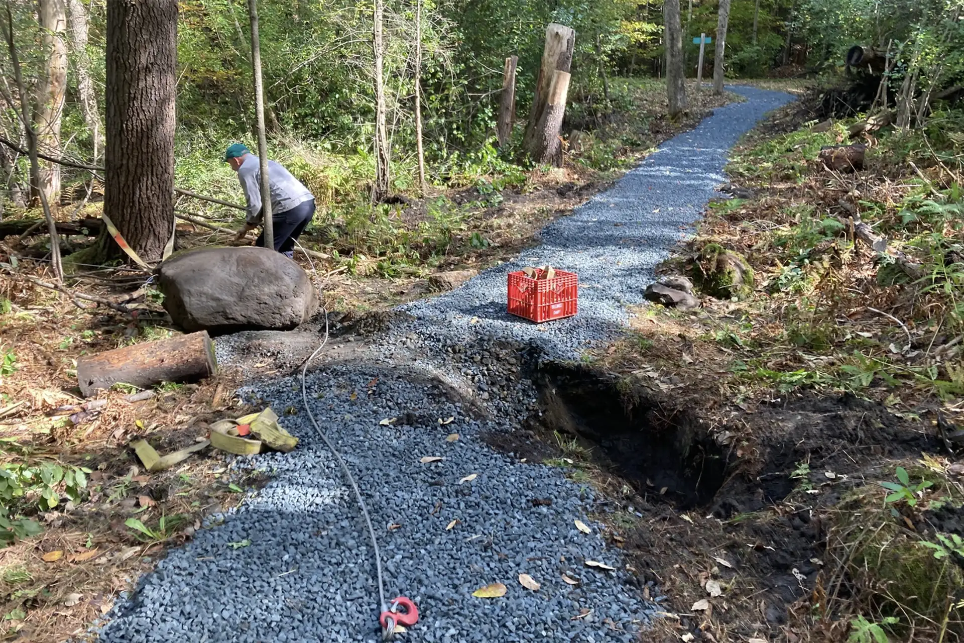 man performing trail work