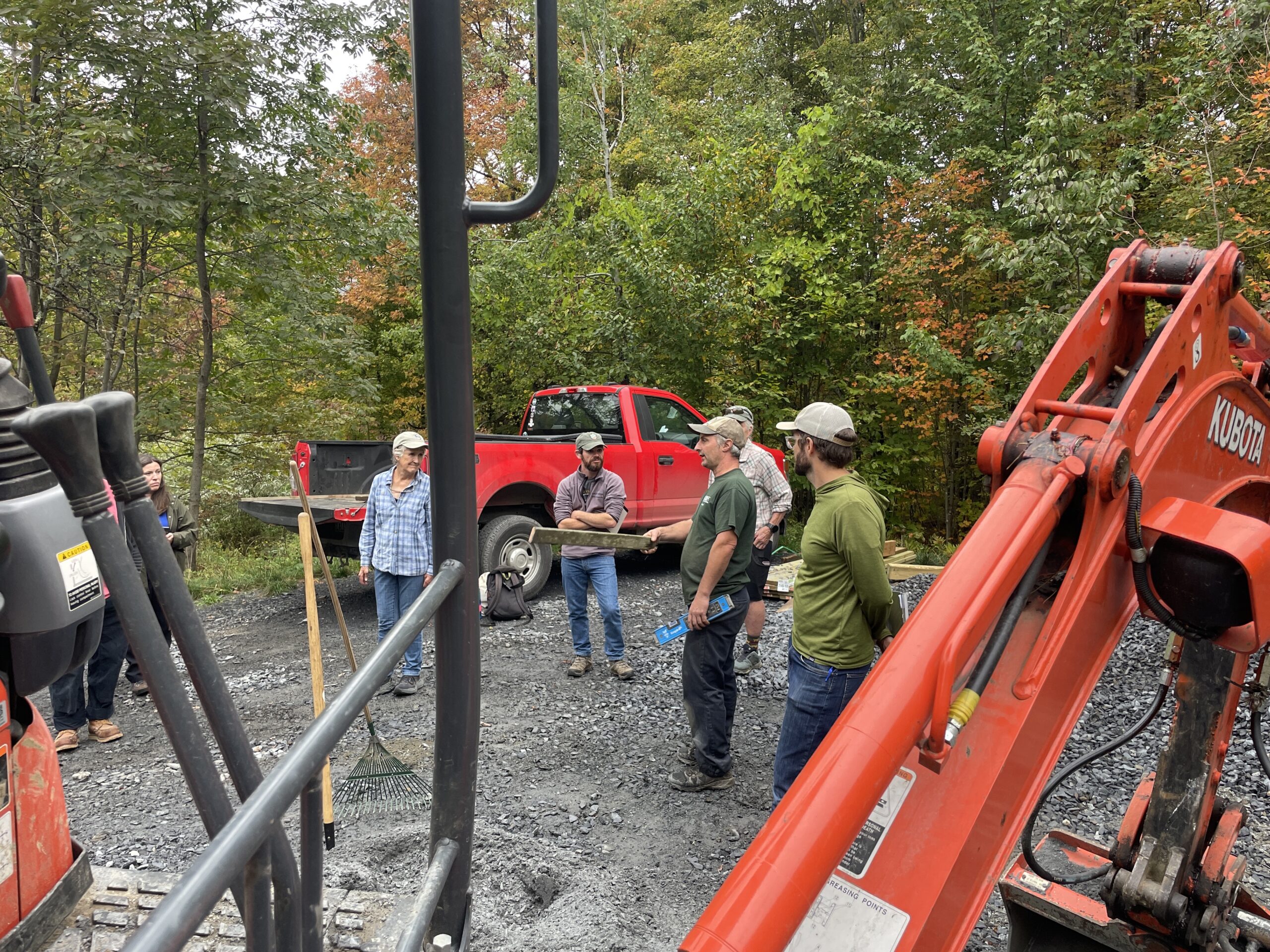 Kubota truck people listening to a man outdoor workshop