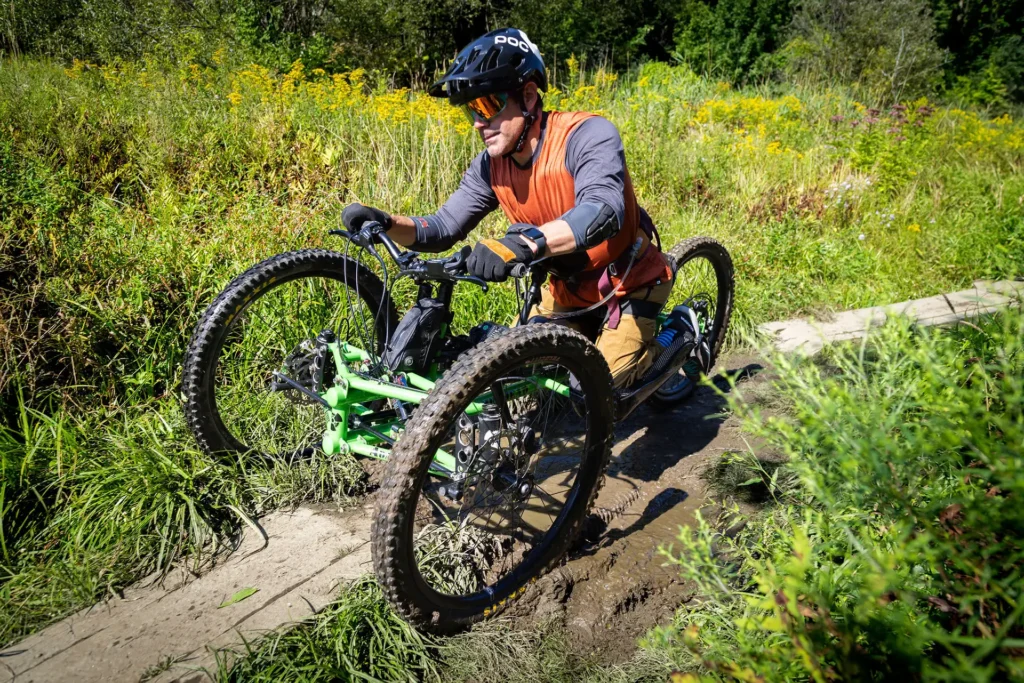 mountain biker on acessible bike riding on trail