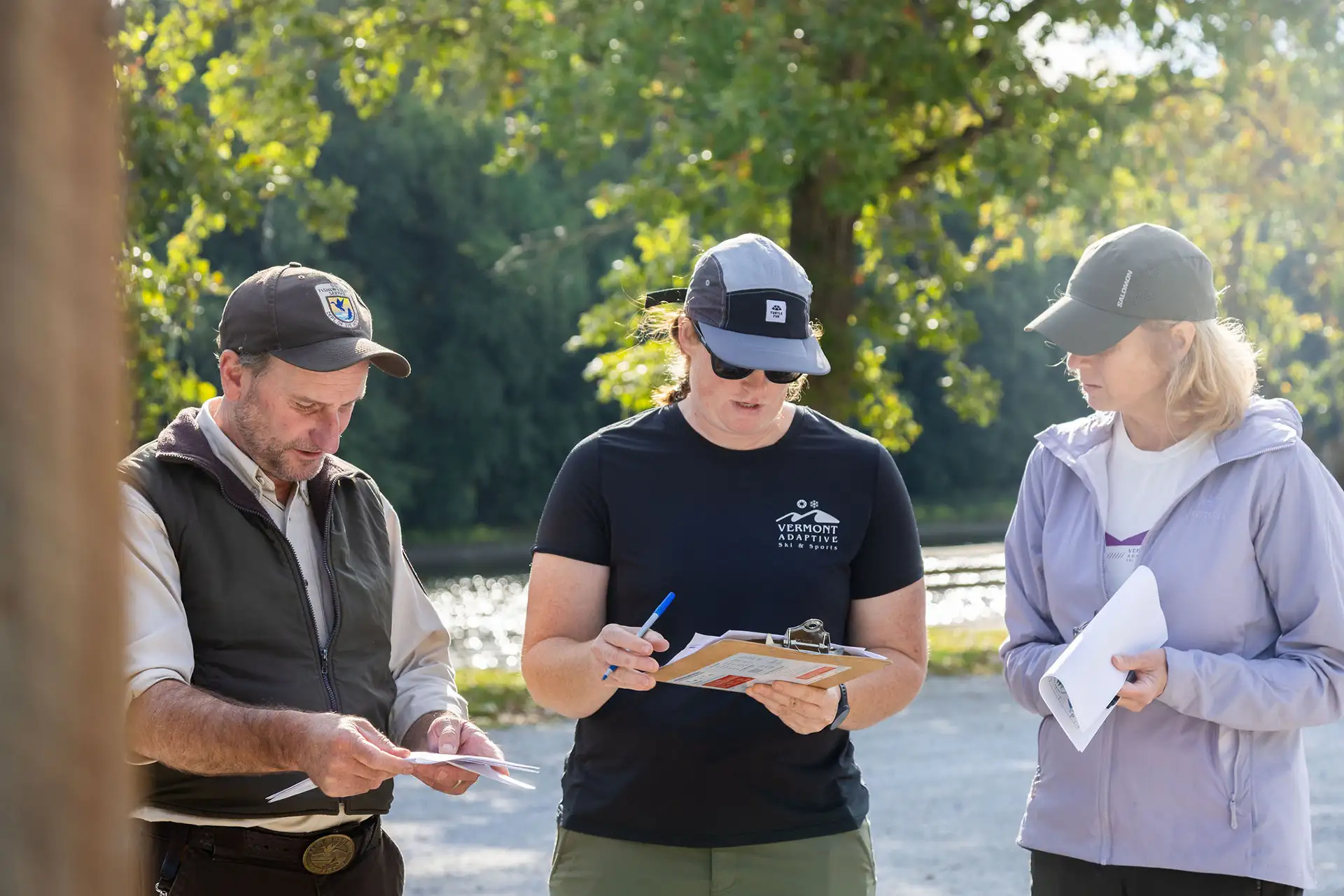 vermont adaptive staff member USFW and community member reviewing paperwork