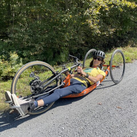 Lamoille valley rail trail flat hard stone trail in woods person in handcycle