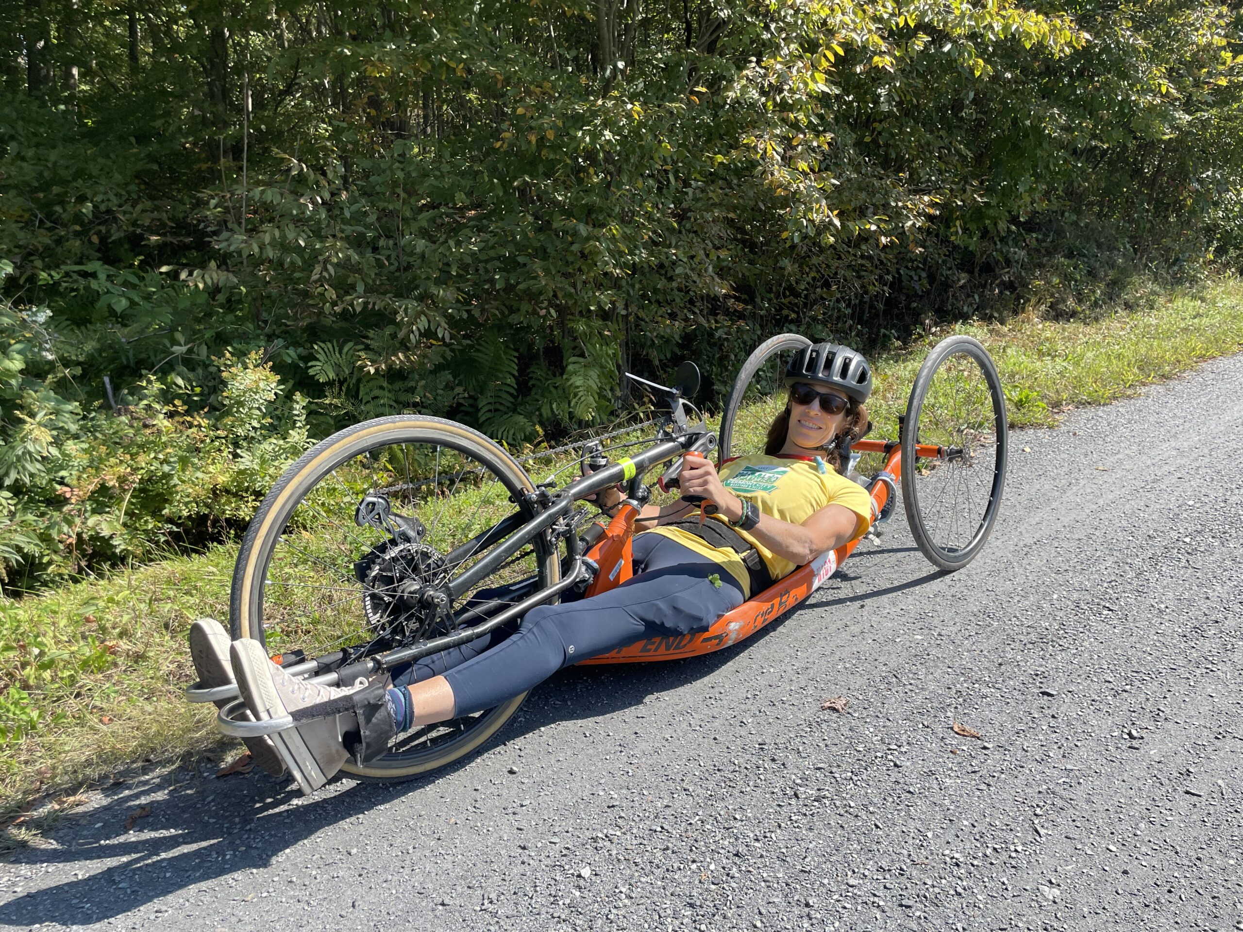 Lamoille valley rail trail flat hard stone trail in woods person in handcycle